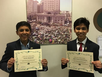 arjun and nyan holding up certificates